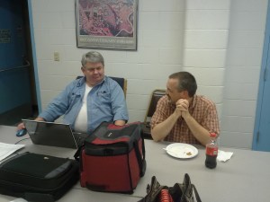 Mark Morrissey's skeptical look in response to Bill Martin's claim that he can eat more potluck than Mark.